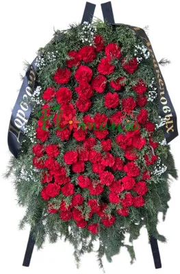 Большой траурный венок из красных гвоздик
