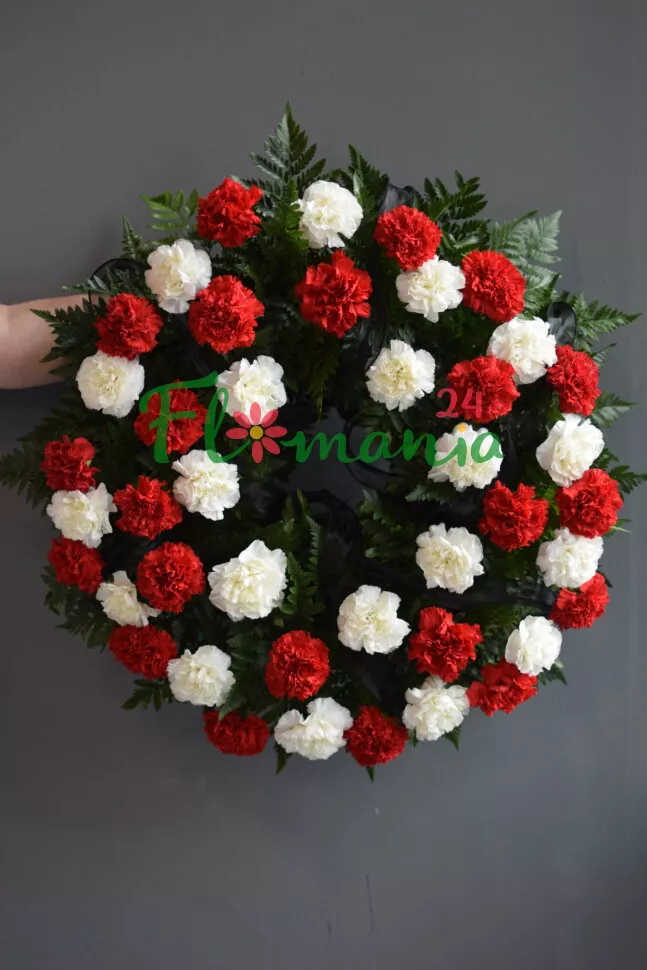 Траурный венок из красных и белых гвоздик